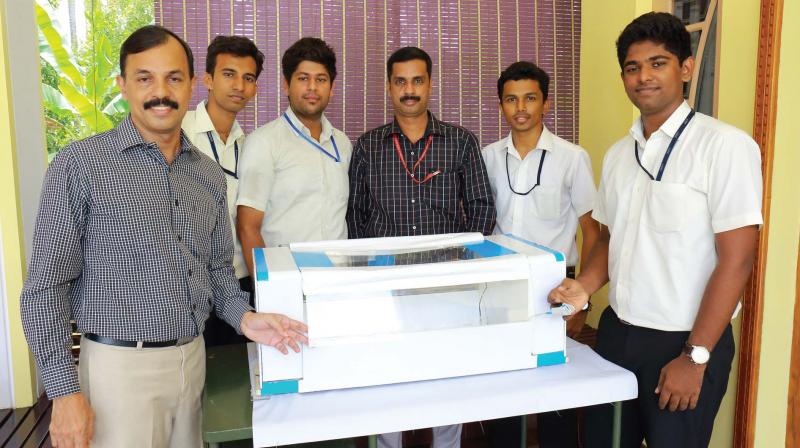 Students and their guide with the prototype of low-cost, portable incubator.