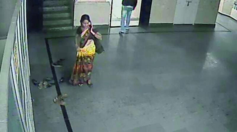 A CCTV grab shows a woman suspected to have taken away the baby and the man she met.