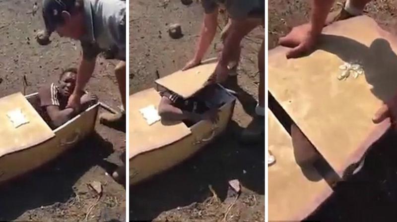 The 20-second video clip shows a man wearing khaki coloured hat, shirt and short pants, probably a farmer, trying to stuff the wailing victim in a coffin, threatening to set him on fire. (Photo: YouTube Screengrab)