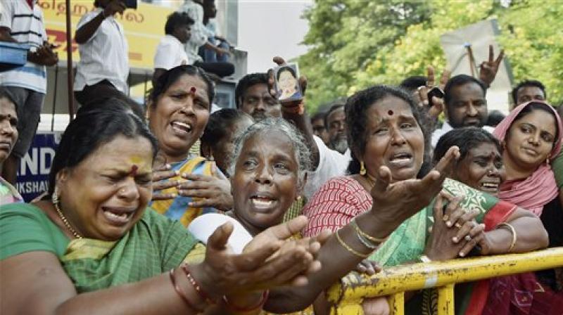 Supporters of Tamil Nadu Chief Minister Jayalalithaa cry in front of Apollo hospital. (Photo: PTI)
