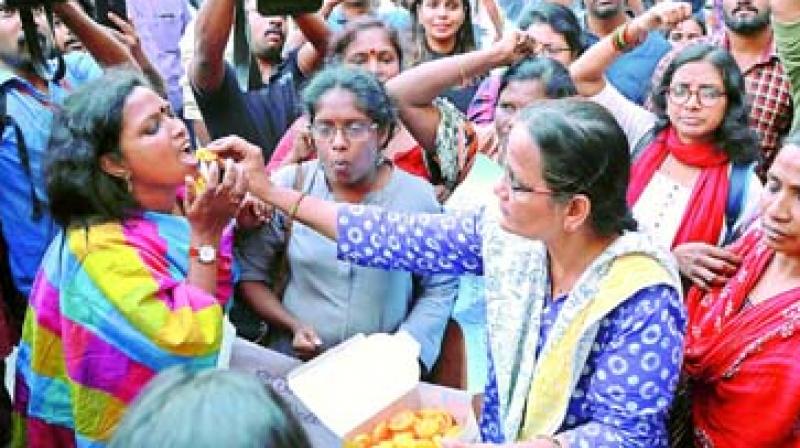 Gender activists celebrate the successful entry of two women into the Sabarimala Temple, at the High Court Junction in Kochi on Wednesday. (Photo: ARUN CHANDERABOSE)