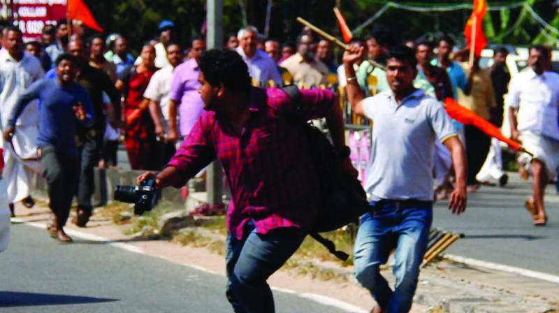 Photo journalist Sreedhar Lal under attack  during the protest march by BJP-RSS workers in Kollam on Wednesday.