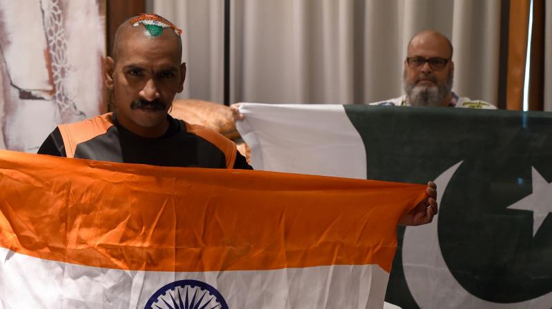 Their governments might not be ready for talks, but that did not stop Pakistans Mohammad Basheer opening his heart, and his wallet, to ensure Indias most recognised cricket fan Sudhir Chaudhary, also known as Sudhir Kumar Gautam, could be at the Asia Cup. (Photo: AFP)