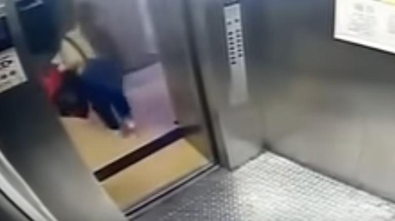 The footage also showed the girl in a yellow t-shirt with dungaree jeans, carrying a gift box along with two plastic bags into the lift. (Photo: Screengrab)