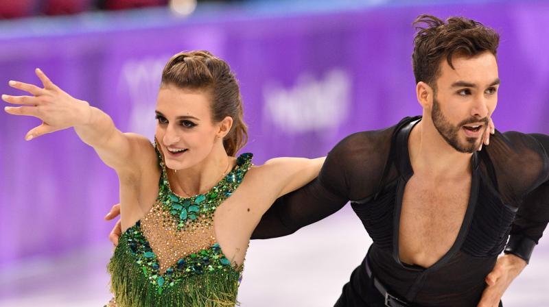 The mishap happened when the 22-year-old Gabriella Papadakis leaned backwards early on and her partner, Guillaume Cizeron inadvertently unclipped the back of her green costume. The duo were still able to finish their short dance as Papadakis tried to keep her chest covered, but she left the ice in tears. (Photo: AFP)