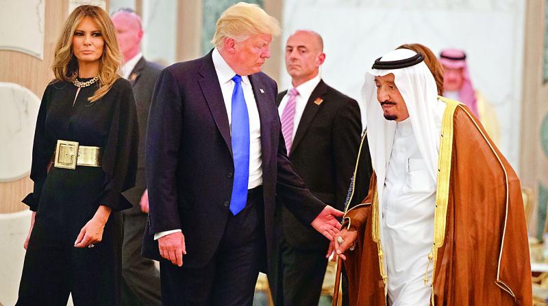 President Donald Trump and First Lady Melania Trump walk with Saudi King Salman to a coffee ceremony and presentation ceremony of The Collar of Abdulaziz Al Saud Medal at the Royal Court Palace on Saturday. (Photo: AP)