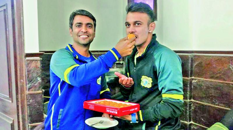 Siddarth Kaul (right) is congratulated by Punjab coach Ajay Ratra at Amritsar, after he received his maiden call for the Indian team on Monday.