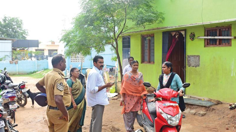 Cops and officials outside the home in Madurai. (Photo: DC)