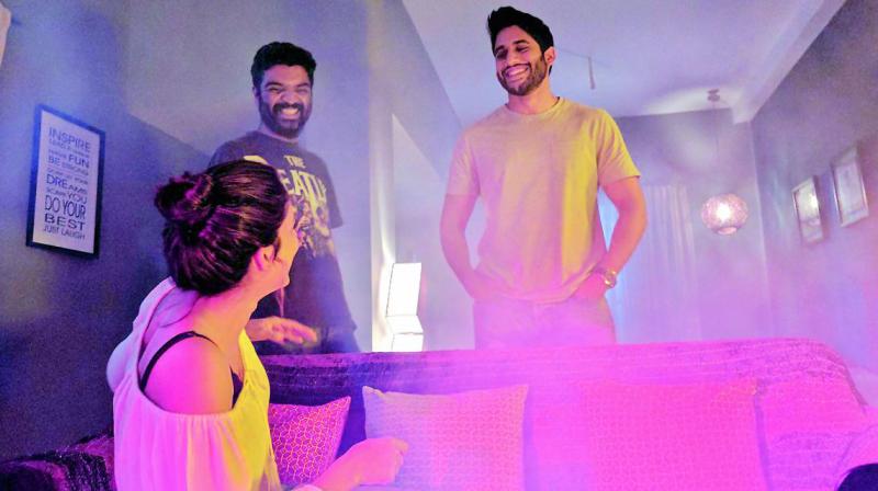 Naga Chaitanya, director Krishna Marimuthu and Lavanya Tripathi share a light moment on the sets of the film