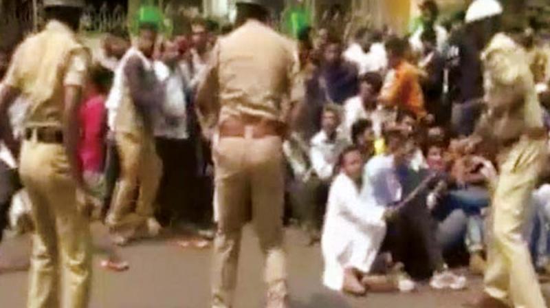 A file photo of police caning PFI activists in Mangaluru