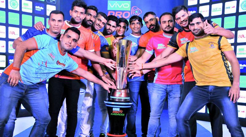The captains strike a pose with the trophy on the eve of the tournament. (Photo: P. Surendra)