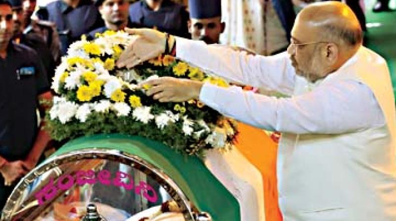 BJP National President Amit Shah pays tribute to Union Minister Ananth Kumar during his funeral in Bengaluru on Tuesday.
