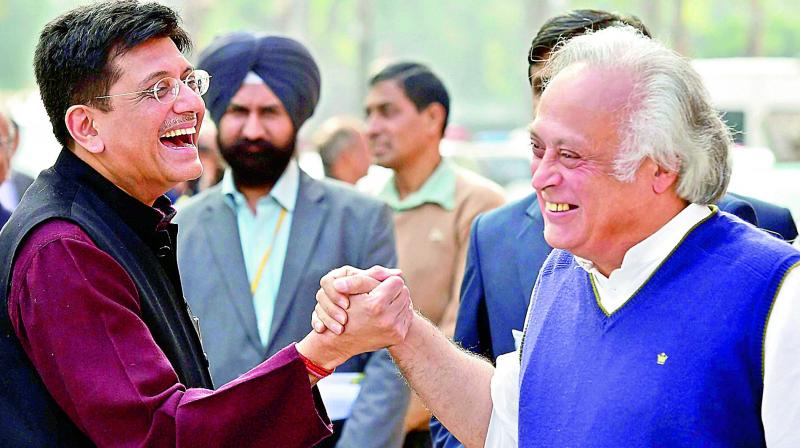 Union minister Piyush Goyal (L) shares a light moment with Congress member Jairam Ramesh at Parliament on Monday. (Photo: PTI)