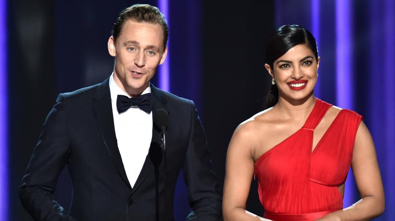 Priyanka Chopra with Tom Hiddlestone on the Emmy Awards stage in 2016. (Photo: AP)