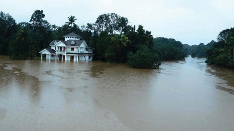 A house stands immersed in flood waters at Moovattupuzha during the deluge in August 2018. (File pic)
