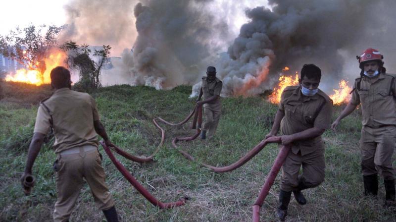 Fire force personnel engaged in dousing the blaze that broke out at a deserted grassland near ecologically sensitive Mangalavanam in Kochi on Saturday evening. Fire tenders could not reach the spot due to the narrow way leading to it, which slowed down the firefighting. The fire was brought under control by around 8.30 pm.  (SUNOJ NINAN MATHEW)