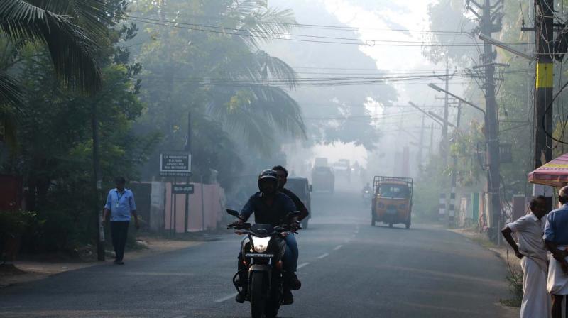 Fog enveloped many parts of Kochi on Saturday morning after smoke emanated from the waste dump at Brahmapuram waste processing plant even 17 hours after the fire.   (ARUN CHANDRABOSE)