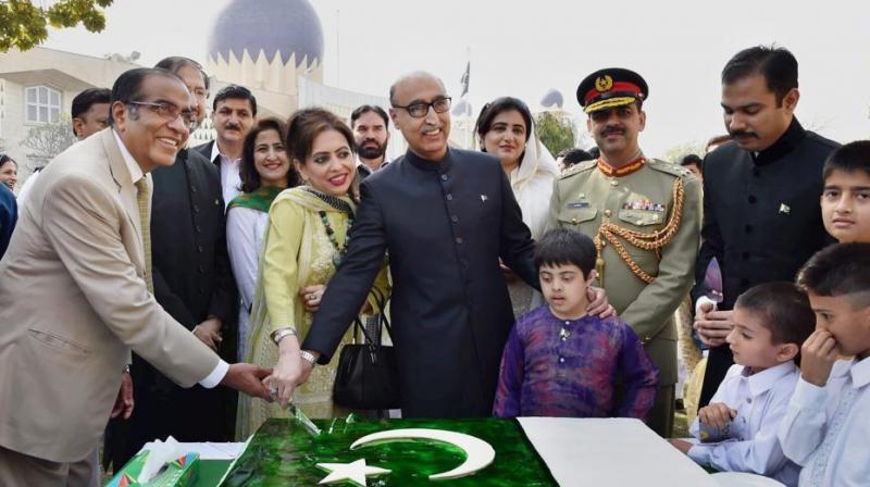 Pakistan high commissioner Abdul Basit cuts the cake during the Pakistan Day celebrations in New Delhi on Thursday. (Photo: PTI)