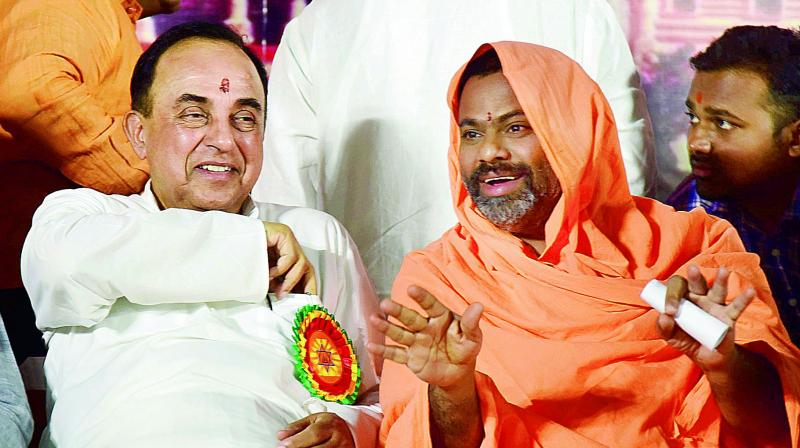 Senior BJP leader Dr Subramanian Swamy has a word with Swami Paripoornananda at a talk on â€œBuilding Ram Mandir in Ayodhya through legal frameworkâ€ in Hyderabad on Sunday. (Photo: DC)