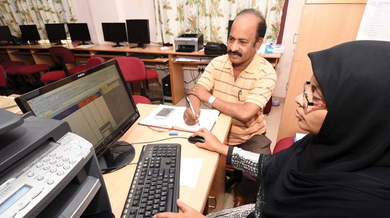 P.K Chandran, principal of Kendriya Vidyalaya-1, East Hill, checks the results on Sunday.