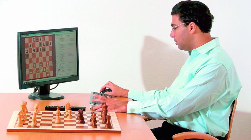 A file photo of Grandmaster Viswanathan Anand playing chess with a computer.