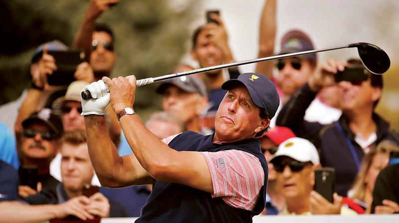 Phil Mickelson hits from the fifth tee during the four-ball golf matches on the second day of the Presidents Cup at Liberty National Golf Club in New Jersey on Friday. 	(Photo: AP)