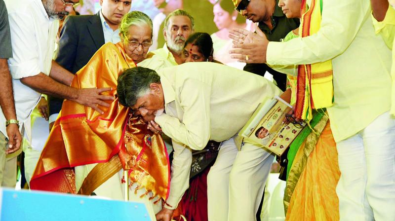 Chief Minister N. Chandrababu Naidu takes blessings from an elderly woman during Janmabhoomi programme at JNTUK in Kakinada on Friday.  (DC)