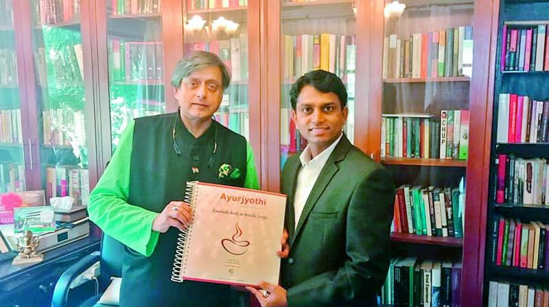 Former Union minister Shashi Tharoor releases the second  edition of Ayurjyothi in Braille. Author of the book Dr Anil Kumar Puli, a native of Warangal, is also seen. 	 (DC)