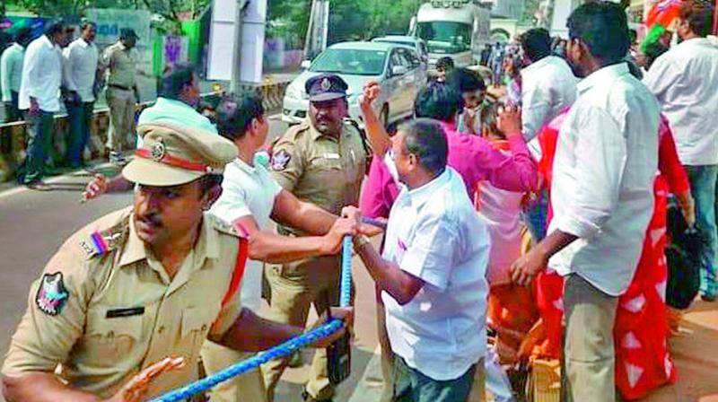 Police detain BJP activists when they tried to stop Chief Minsiter N. Chandrababu Naidus convoy in Kakinada on Friday.  (DC)