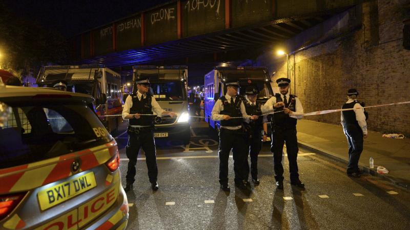 Police officers man a cordon at Finsbury Park where a vehicle struck pedestrians in London Monday. (Photo: AP)