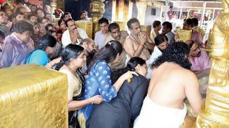 The photograph circulating in social media of women in the prohibited age group in the sanctum sanctorum of the Sabarimala Ayyappa temple recently. (File photo)