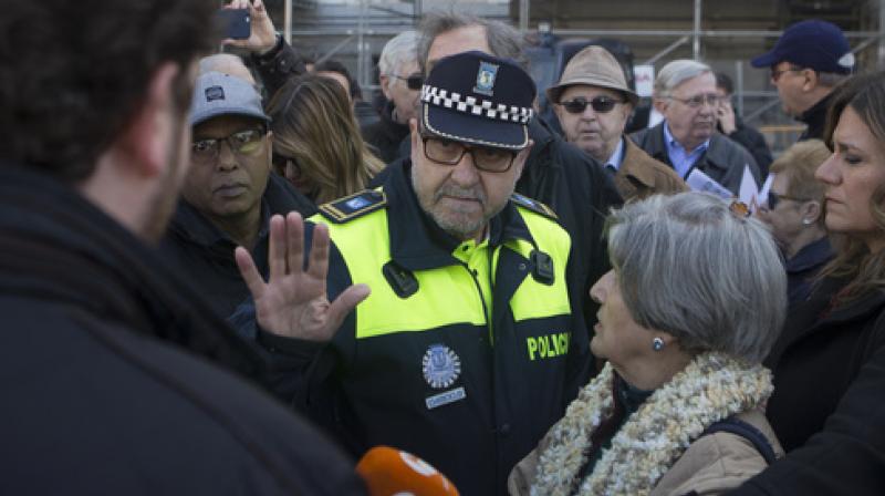 A police officer speaks with protesters from the Hazte Oir (Make Yourself Heard) organization during a protest outside the Town Hall in Madrid, Spain, Wednesday, March 1, 2017. Madrid authorities say they have impounded an orange-and-white bus used by a group campaigning to outlaw children changing their gender. Madrid Mayor Manuela Carmena said Wednesday that police stopped the bus returning to the Spanish capitals streets in order to prevent a hate crime. (Photo: AP