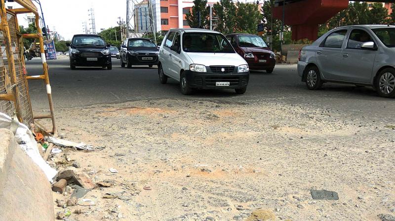 Pothole-ridden roads in HSR Layout are causing congestion right at traffic signals. (Photo: DC)