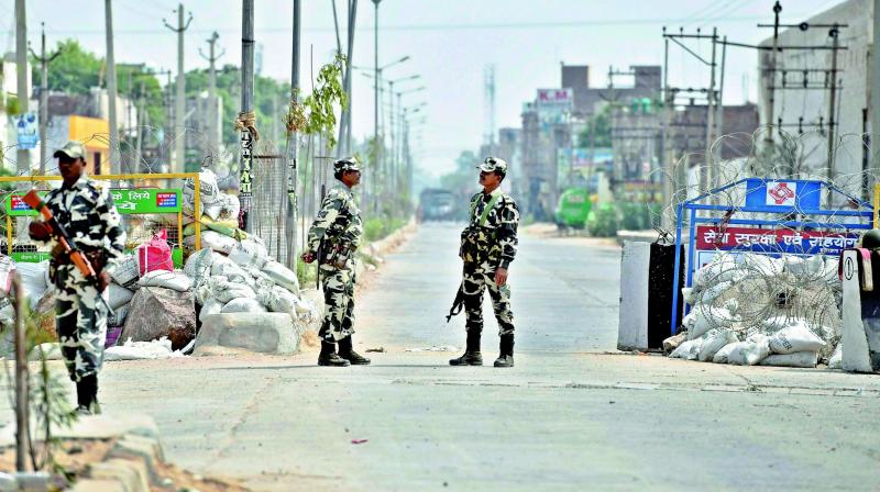 Police forces deployed outside the Dera Sauda ashram during the search in Faridabad on Sunday. (Photo: PTI)