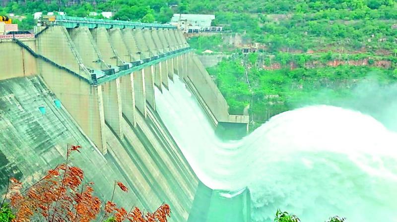 The water level in Srisailam reservoir touched a peak of 881 feet against the full reservoir level of 885 feet before the seven shutters of the dam were opened on Saturday.  (Image: DC)