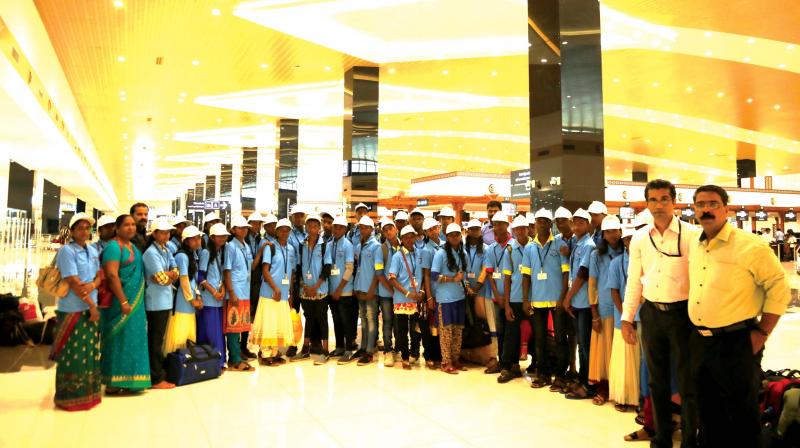 The team of students of Aralam Farm High School who got a flight trip pose for a snap with teachers and officials.