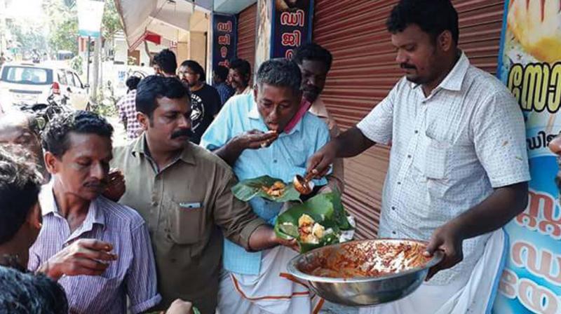 DYFI workers serve tapioca and beef curry free of cost, protesting the BJP hartal against beef stalls.