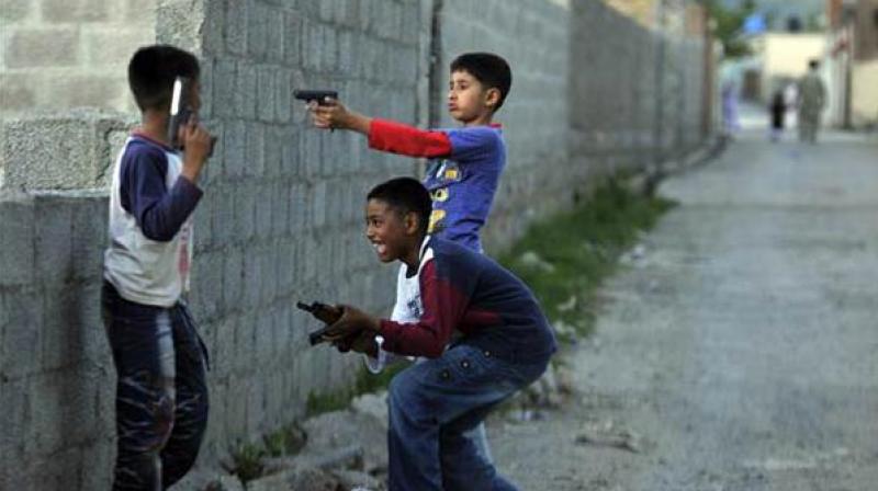 Young boys play with plastic guns. (Photo: AFP/file)