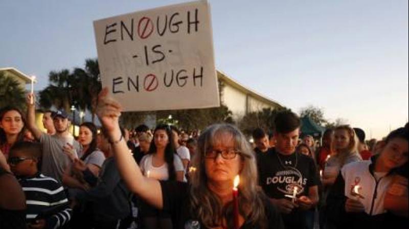 Mourners stand during a candlelight vigil for the victims of Marjory Stoneman Douglas High School shooting in Parkland, Florida, on 15 February 2018. (Photo: AFP.)