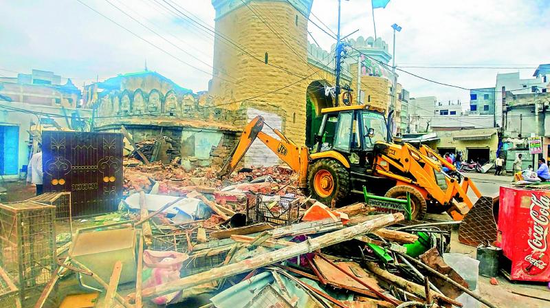 The Archaeological Department along with the officials of the GHMC remove encroachments at the Dabeerpura Darwaza on Tuesday morning.  (Image: P.Surendra)