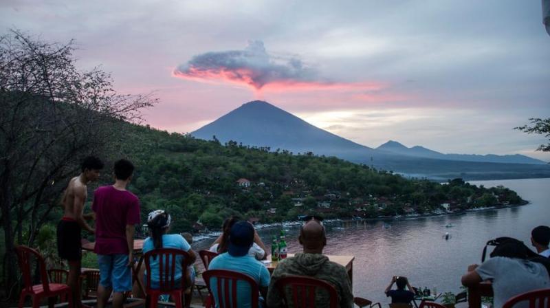 Tourists gather to watch Mount Agung at Amed beach in Karangasem on Indonesias resort island of Bali last week. (Photo: AFP/ File)