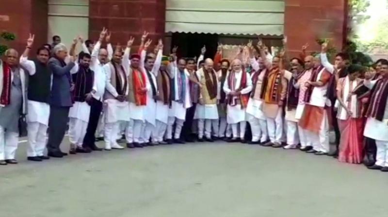 A large contingent of the party members posed with smiles and holding up the victory sign for photos near the Prime Ministers Office. (Photo: Twitter | ANI)