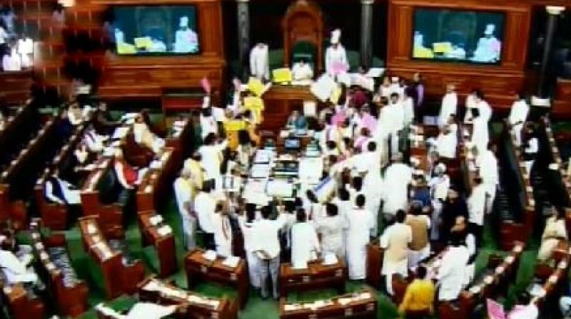 TRS, TDP, AIADMK and YSR Congress members stormed the Well carrying placards and raised slogans in support of their demands. (Photo: ANI | Twitter)