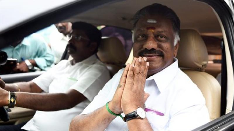 AIADMK Puratchi Thalaivi Amma Faction leader and former Chief Minister O Panneerselvam arriving at his official residence at Greenways Road as part of merger talks with party supporters in Chennai on Friday. (Photo: PTI)