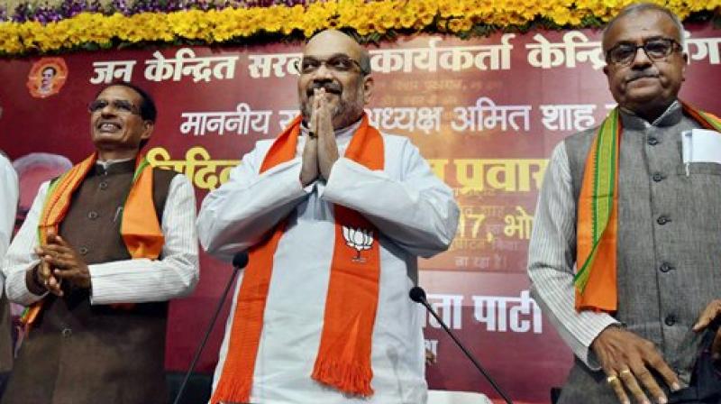 BJP national president Amit Shah with Madhya Pradesh Chief Minister Shivraj Singh Chouhan and state president Nand Kumar Singh Chouhan during his three-day visit to the state, in Bhopal on Friday. (Photo; PTI)