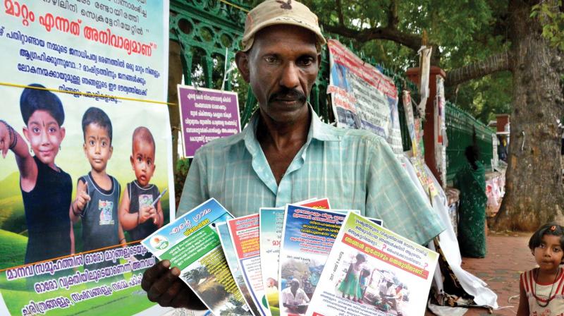 Swaminathan in front of the secretariat on Sunday. Daughter Saneesha looks on (Photo: peethambaran payyeri)