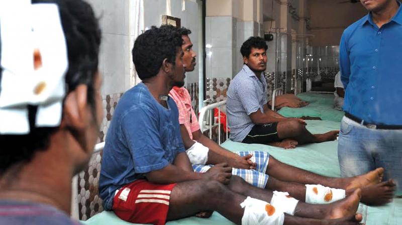 District Collector K. Mohammed Y. Safirulla speaks with the fishermen who survived the tragedy at Fort Kochi taluk hospital (Photo: Sunoj Ninan Mathew)