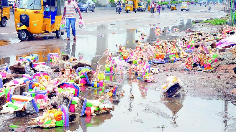 Hundreds of Ganesh idols of less than 2 feet height were dumped on roads in Nagole after heavy rains. They were collected by auto-rickshaw drivers and motorists. (Photo: DC)