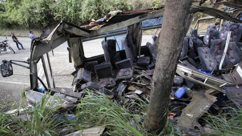 The out-of-control bus smashed into an electric post, shearing off most of its roof. (Photo: AP)