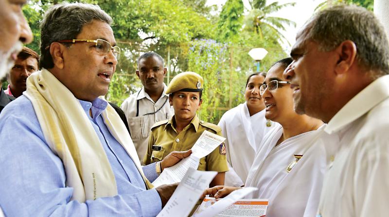 Chief Minister Siddaramaiah listens to peoples grievances during Janata Darshan in Bengaluru on Saturday 	 KPN